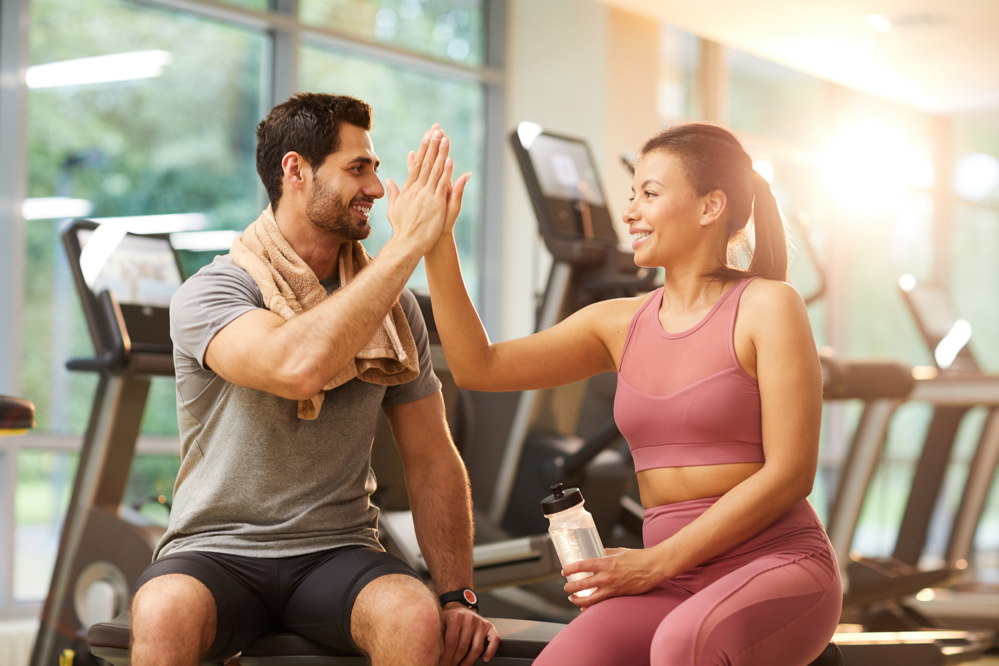 Couple High Fiving in Gym
